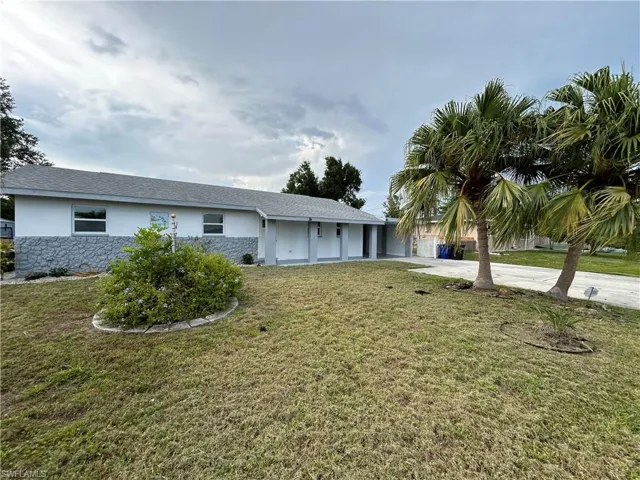 Single story home with a front lawn