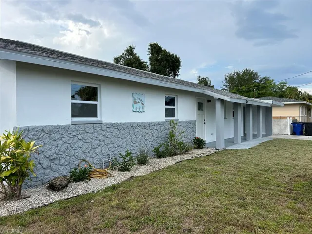 Ranch-style home featuring a front lawn