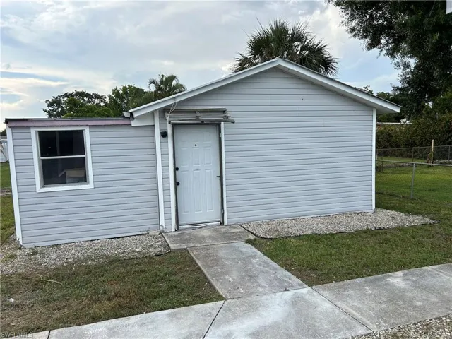 View of exterior entry with a yard