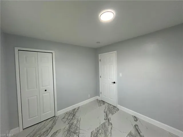 Tiled bedroom with a closet