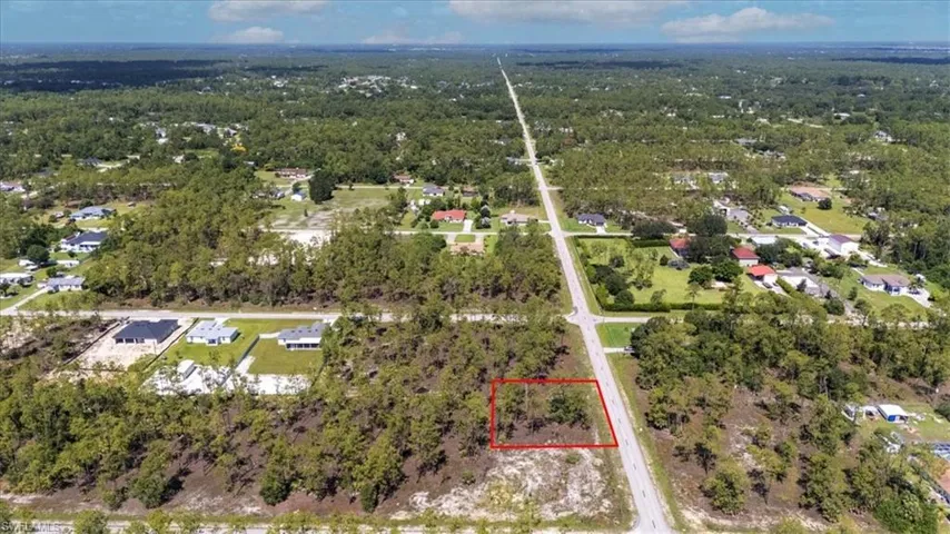 Aerial view of property's location featuring property boundaries highlighted and nearby suburban area
