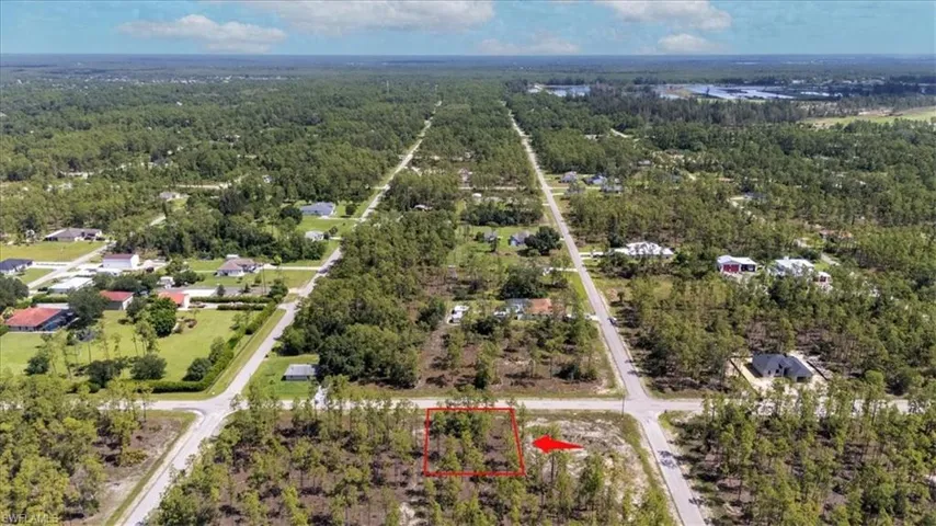 View of property location featuring a heavily wooded area and property parcel outlined