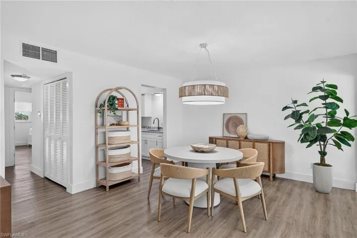 Bright dining area featuring wood-finish flooring and white baseboards