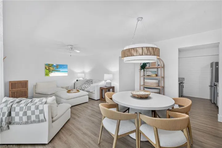 Open-concept living area with wood-finish flooring, a contemporary ceiling fan, and recessed lighting