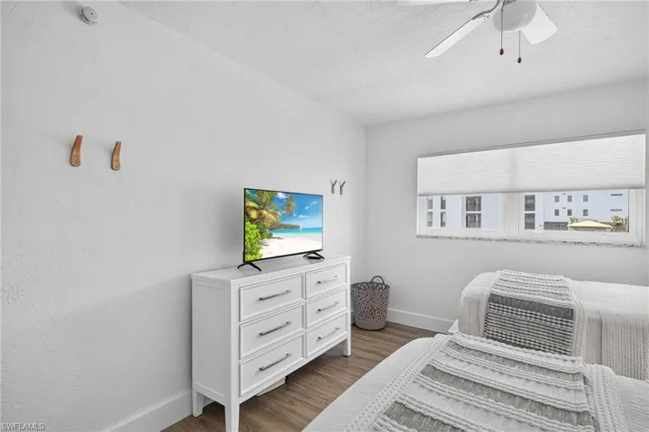 White interior with textured walls and wood-finish flooring