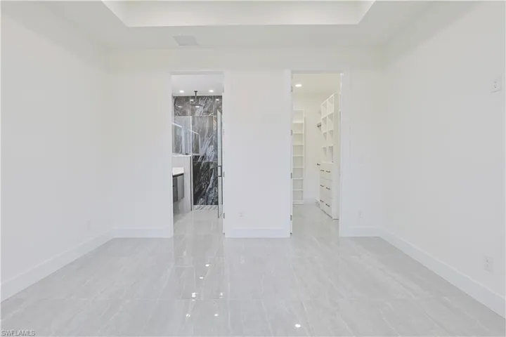 Unfurnished bedroom with a spacious closet and ensuite bathroom