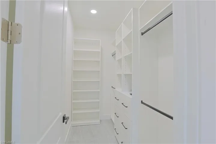 Spacious closet with light tile patterned flooring