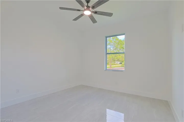 Spare room featuring baseboards
