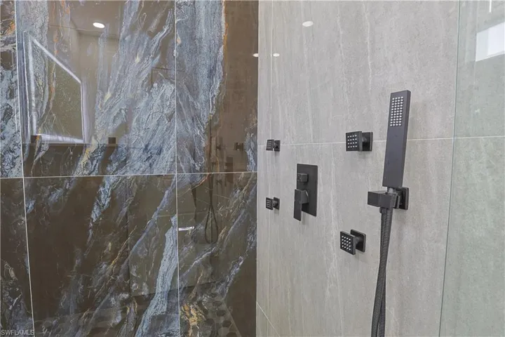 Bathroom featuring a marble finish shower