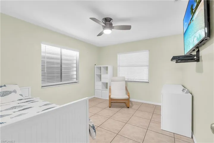 Tiled bedroom with ceiling fan