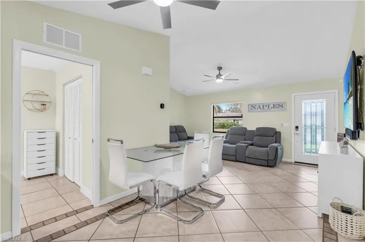 Tiled dining room with ceiling fan
