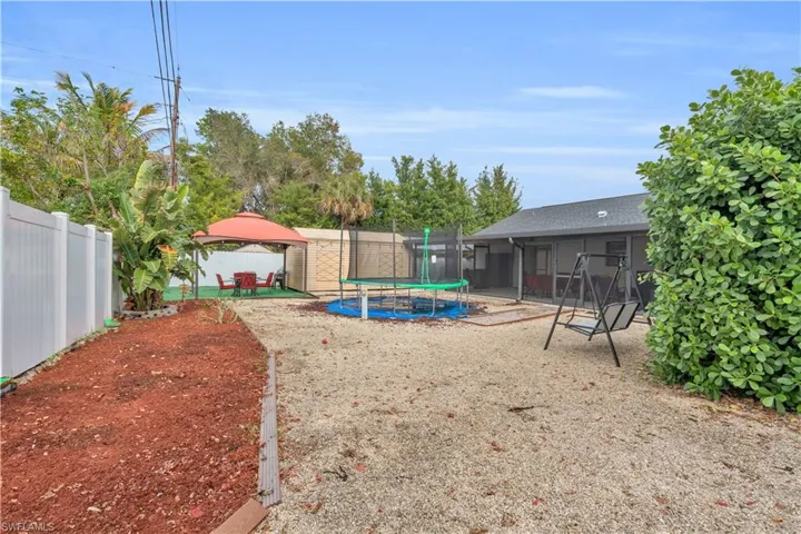 View of yard featuring a patio and a trampoline
