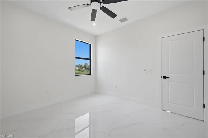 Sleek interior featuring white walls and large format tile flooring