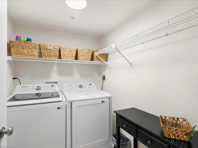Dedicated laundry area featuring a white top-load washing machine and front-load dryer