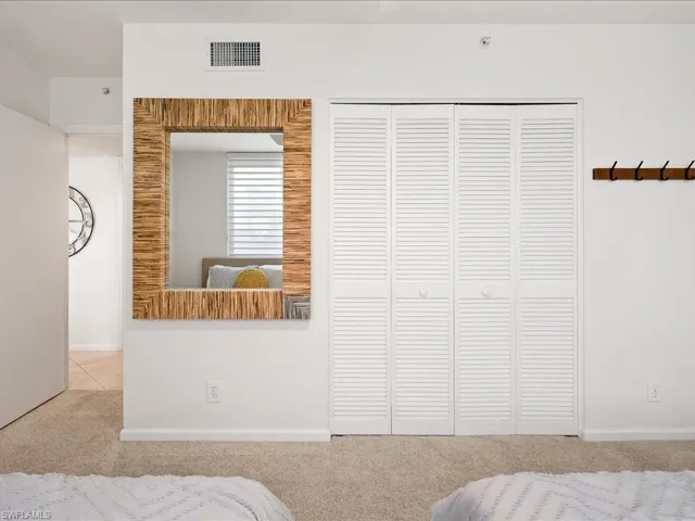 White louvered bifold closet doors with circular pulls