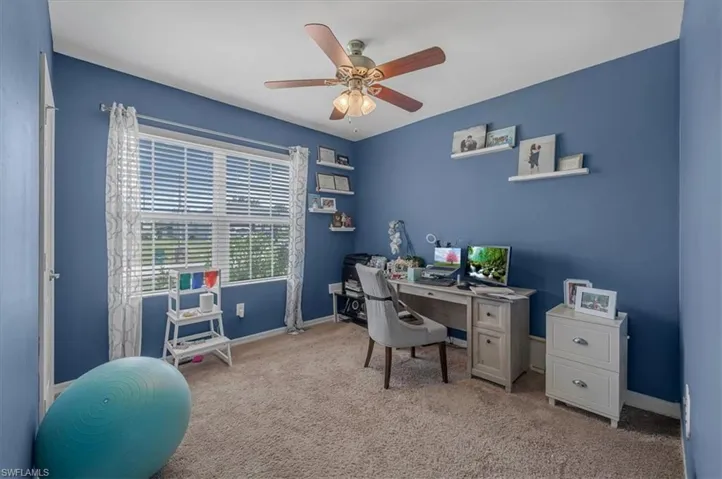 Room featuring a window with horizontal blinds, a ceiling fan with integrated lighting, and carpeted flooring