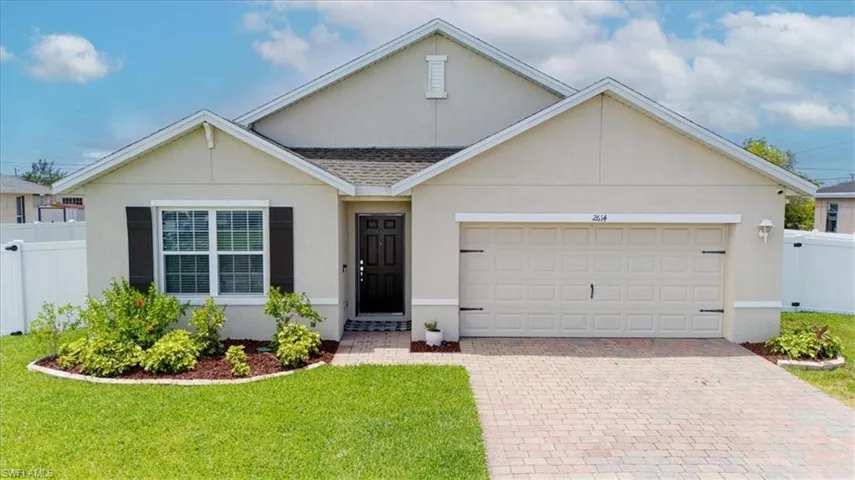 Contemporary stucco exterior with a prominent attached garage