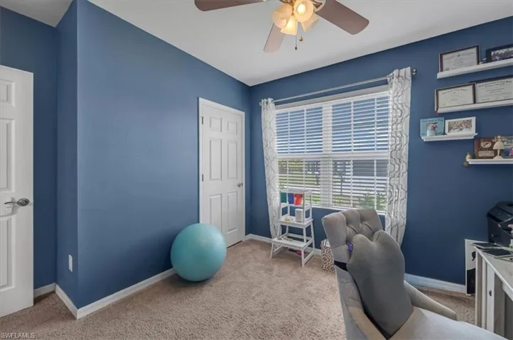 Room featuring blue painted walls and neutral carpet