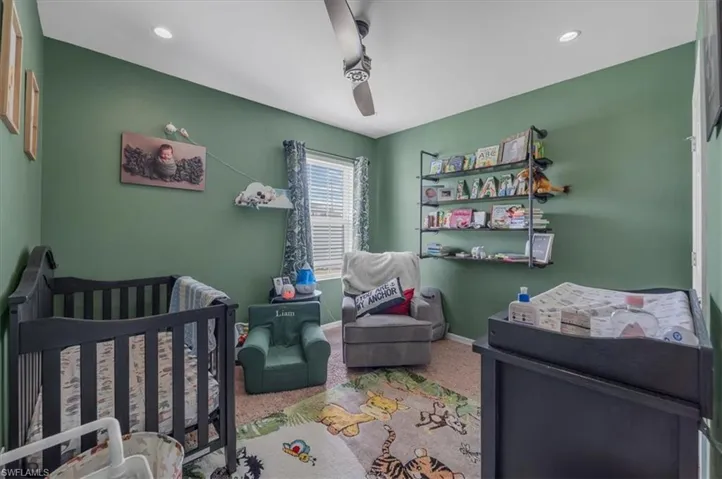 Room with sage green walls, recessed lighting, and a ceiling fan