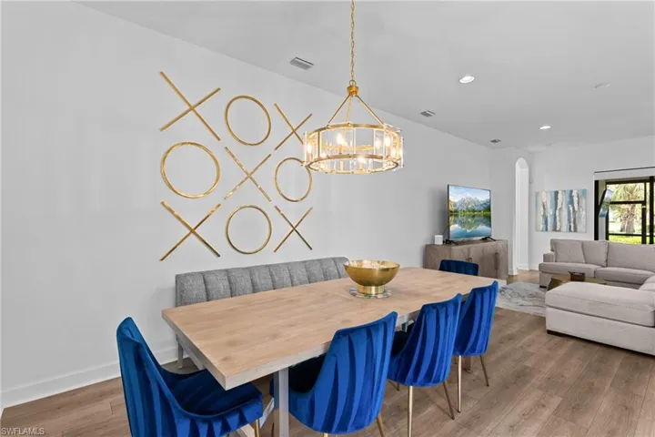 Dining area featuring recessed lighting, baseboards, visible vents, a notable chandelier, and wood finished floors