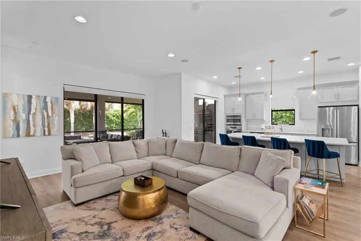 Living room featuring a wealth of natural light, visible vents, light wood-style floors, and recessed lighting