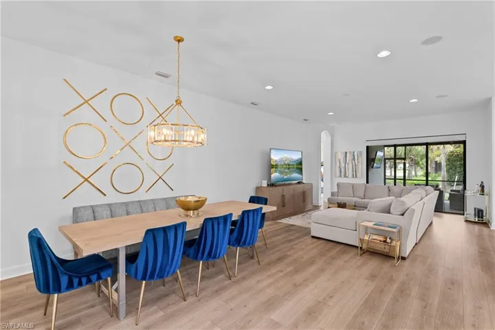 Dining space with visible vents, light wood-style floors, recessed lighting, and a chandelier