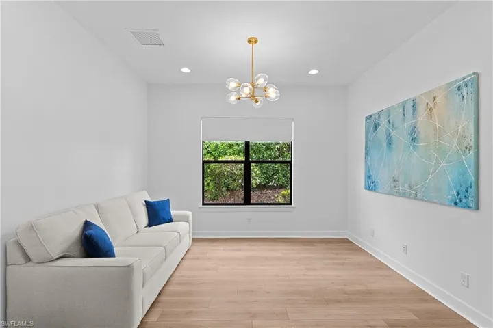 Living area featuring a chandelier, light wood-style flooring, baseboards, visible vents, and recessed lighting