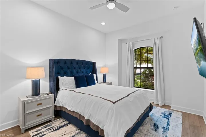 Bedroom featuring baseboards, ceiling fan, wood finished floors, and recessed lighting