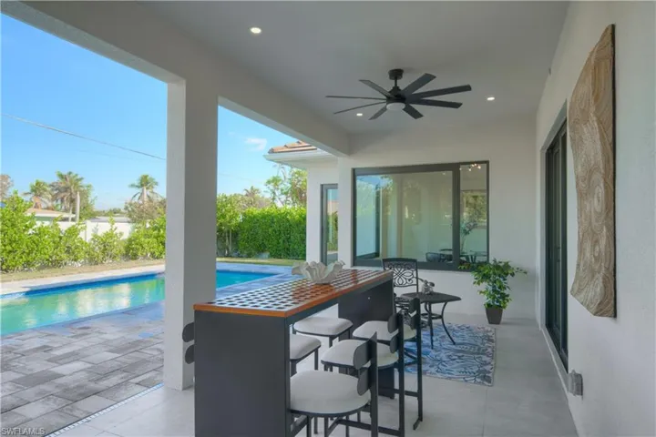 View of pool with a patio and ceiling fan