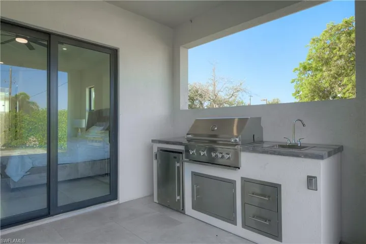 View of patio / terrace with area for grilling, exterior kitchen, and sink