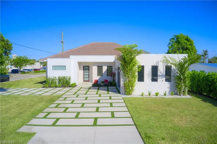 Back of house with a lawn