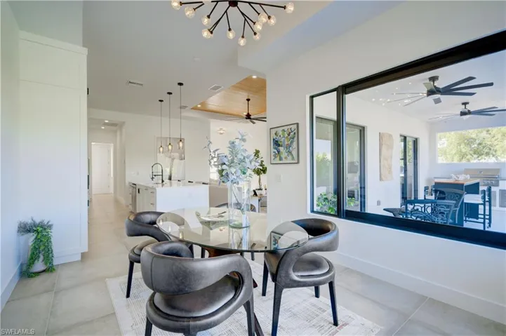 Dining room with sink and a notable chandelier