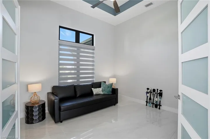 Sitting room featuring baseboards and ceiling fan