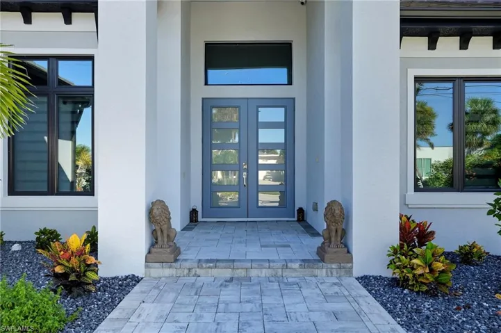 Doorway to property with stucco siding and french doors