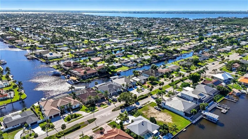 Aerial perspective of suburban area with a nearby body of water