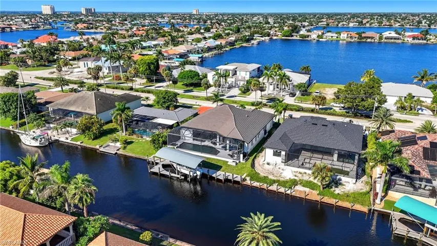 Aerial perspective of suburban area featuring a large body of water