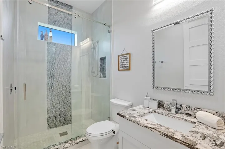 Full bathroom with vanity and a stall shower