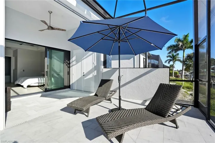 View of patio / terrace featuring a sunroom, a ceiling fan, and a lanai