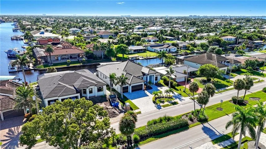 Aerial perspective of suburban area featuring a large body of water
