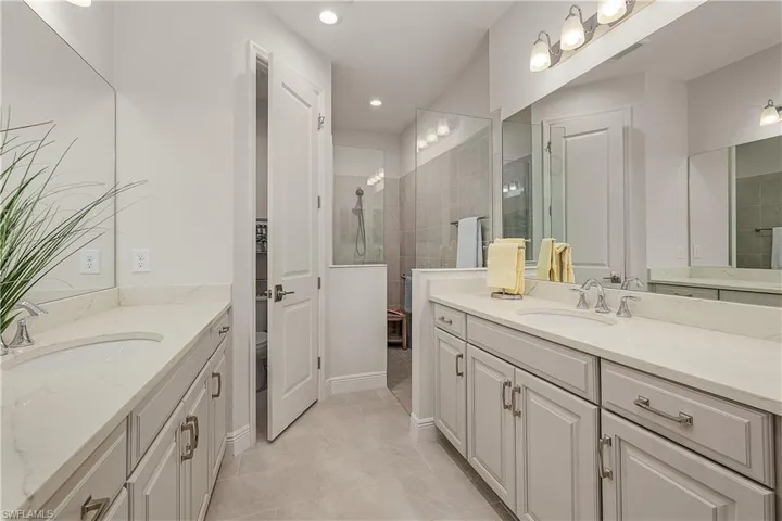 Bathroom with tile patterned floors and vanity
