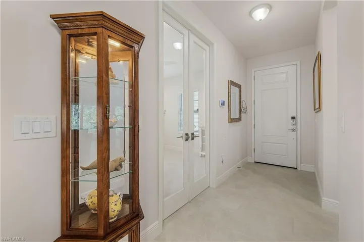 Corridor featuring a wealth of natural light and light tile patterned floors