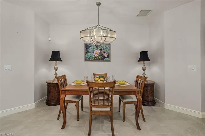 Dining room with a chandelier and light tile patterned floors
