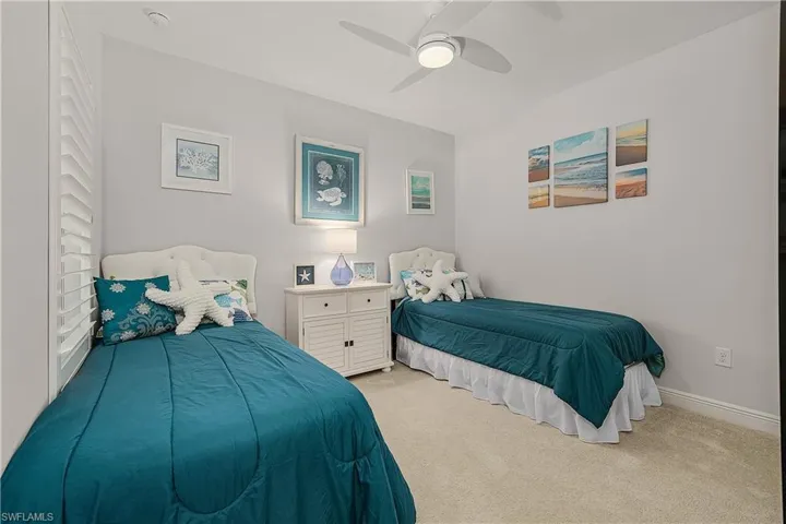 Bedroom with light colored carpet and ceiling fan