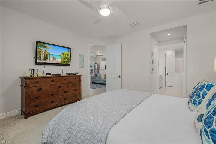 Bedroom featuring light colored carpet and ceiling fan