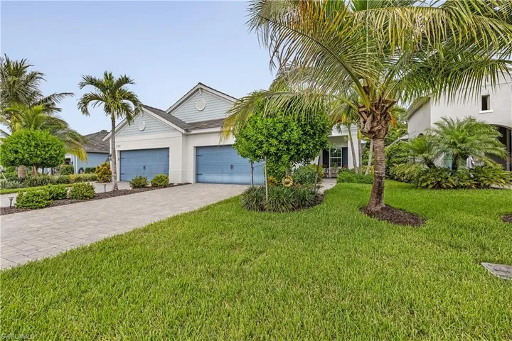 View of front of house with a garage and a front yard