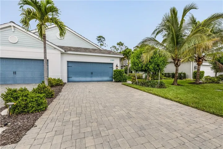 View of front of property featuring a garage and a front yard