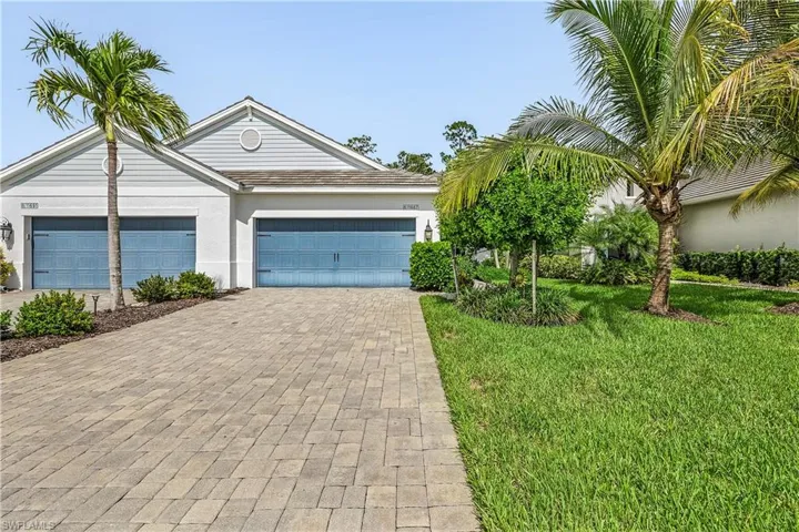 View of front of house with a garage and a front yard