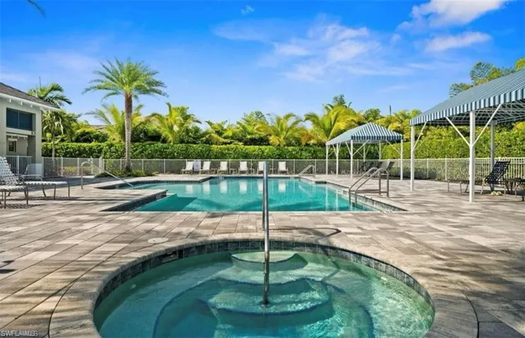 View of swimming pool with a patio and a community hot tub