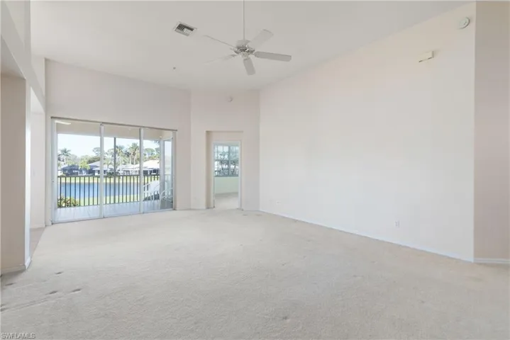 Living Room with Golf Course + Water Views & High Vaulted Ceilings