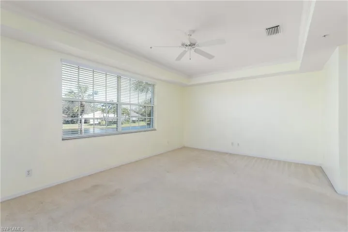 Primary Bedroom Featuring Tray Ceiling with Crown Moulding 2 Walk-In Closets & Beautiful Views